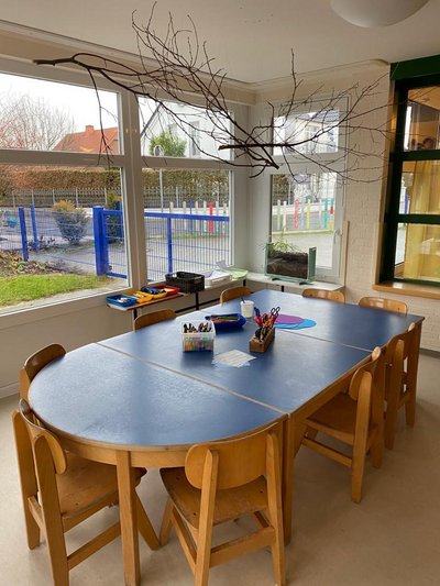 Tisch mit Stühlen in Kindergartengruppe für kreative Arbeiten